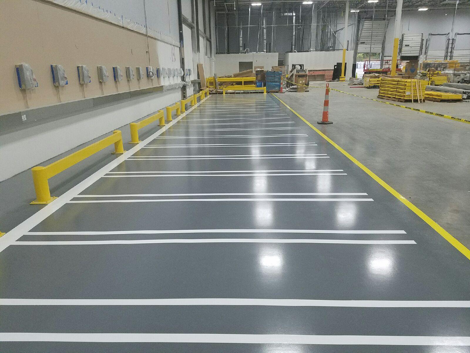 Automotive Epoxy Floor Coating installed by Liquid Floors using Decorative Flakes and Line Striping